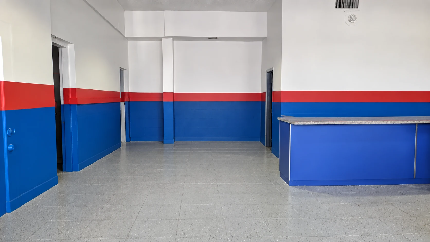 Left side of the West section showroom at 830 NE 79th St, with doors to the restrooms and rear office.